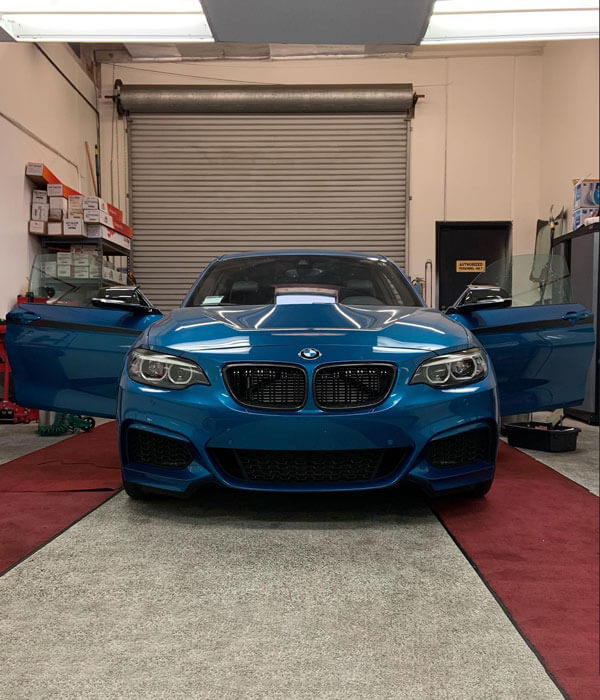 window tint on blue BMW with doors open