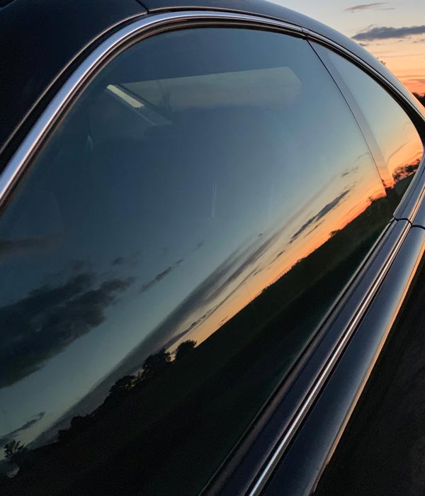 Car with tinted windows at sunset
