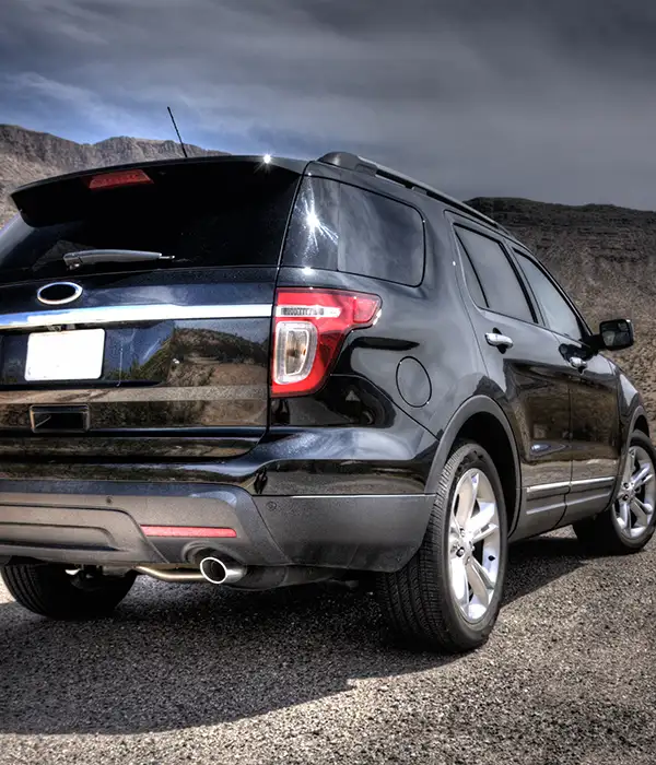 Black, shiny SUV with tinted windows withstanding the desert heat